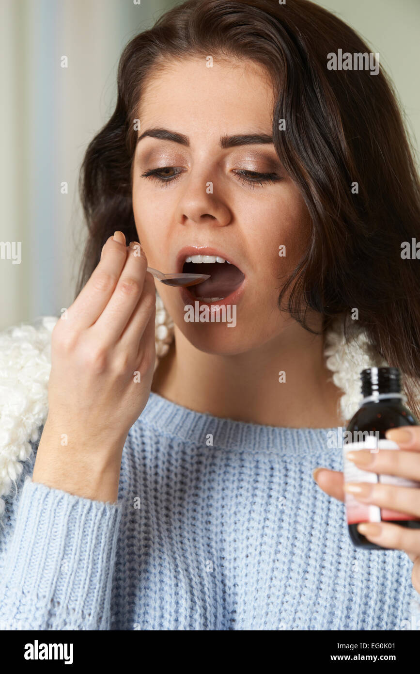 Woman With Cold Taking Medicine On Spoon Stock Photo