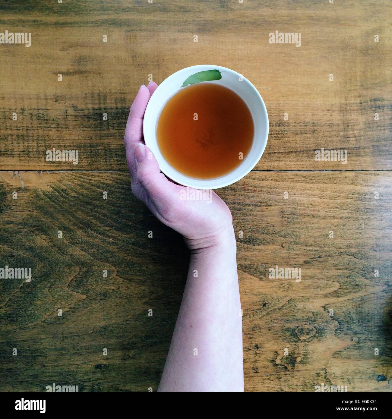 Hand with cup of tea Stock Photo
