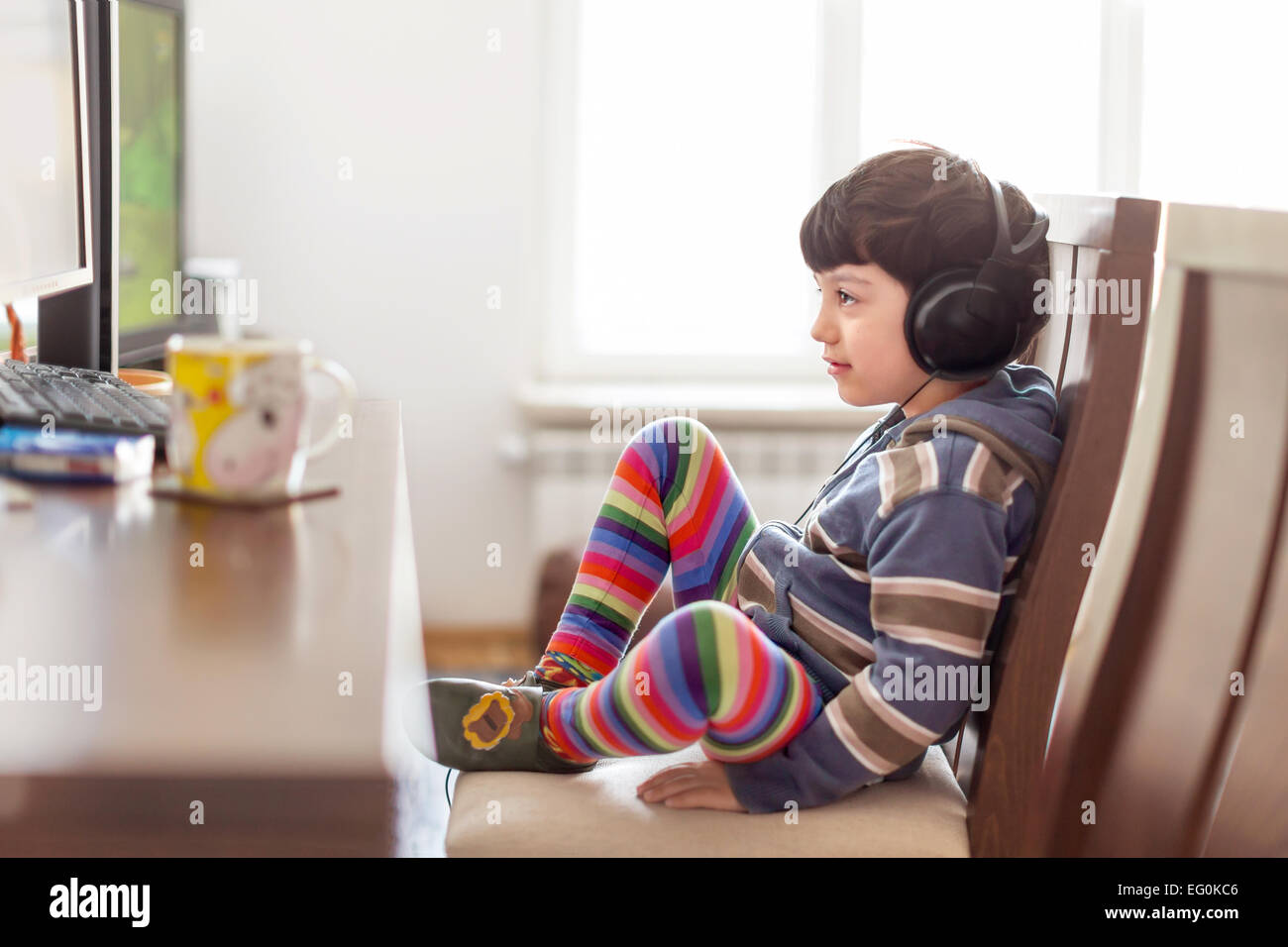 Young boy (4-5) watching movie on PC Stock Photo