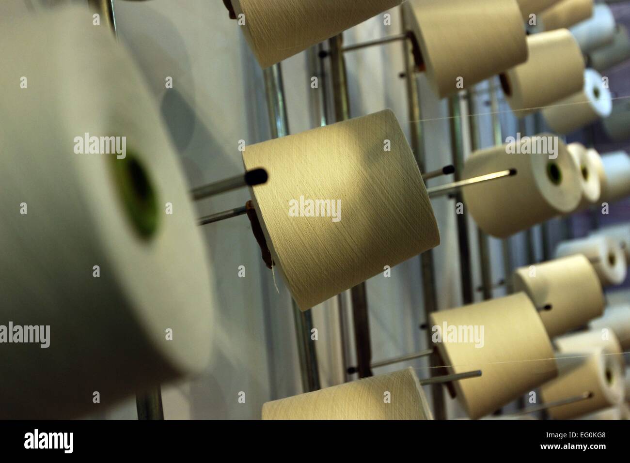 Dhaka 09 February 2015. Group of bobbin thread cones on a warping ...