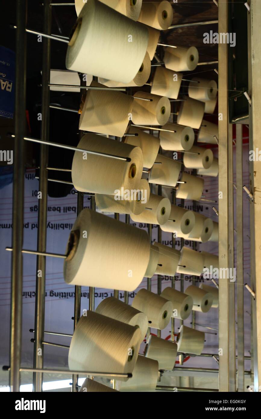 Dhaka 09 February 2015. Group of bobbin thread cones on a warping ...