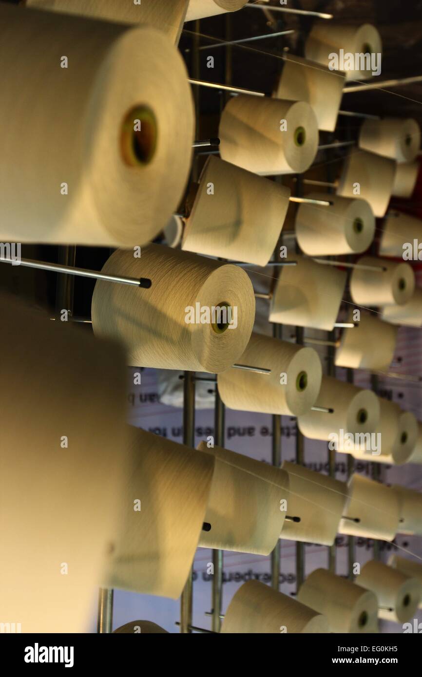 Dhaka 09 February 2015. Group of bobbin thread cones on a warping ...