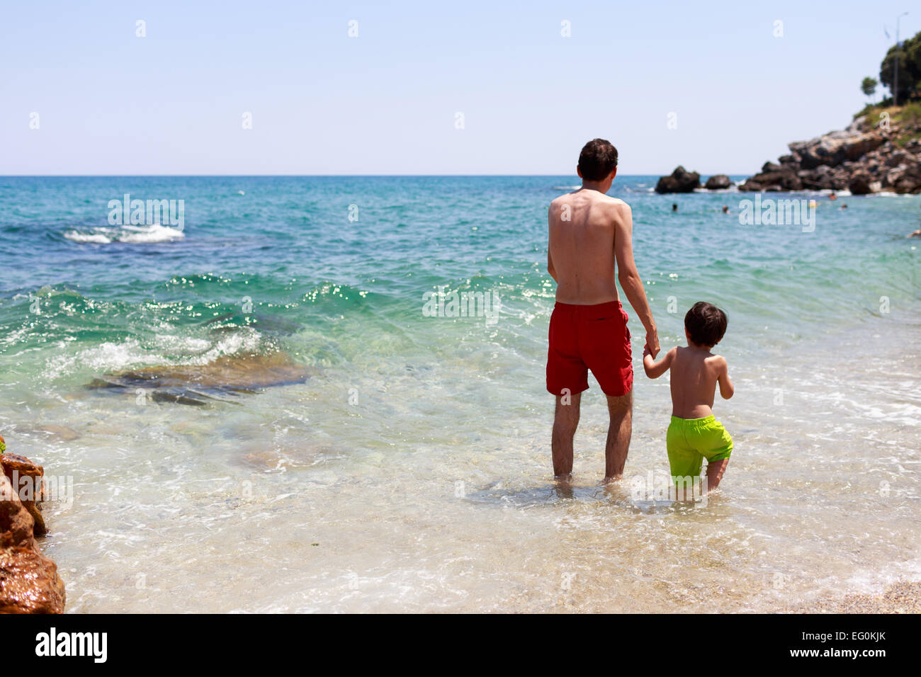 Greece, Thessaloniki, Father and son (4-5) walking in sea Stock Photo