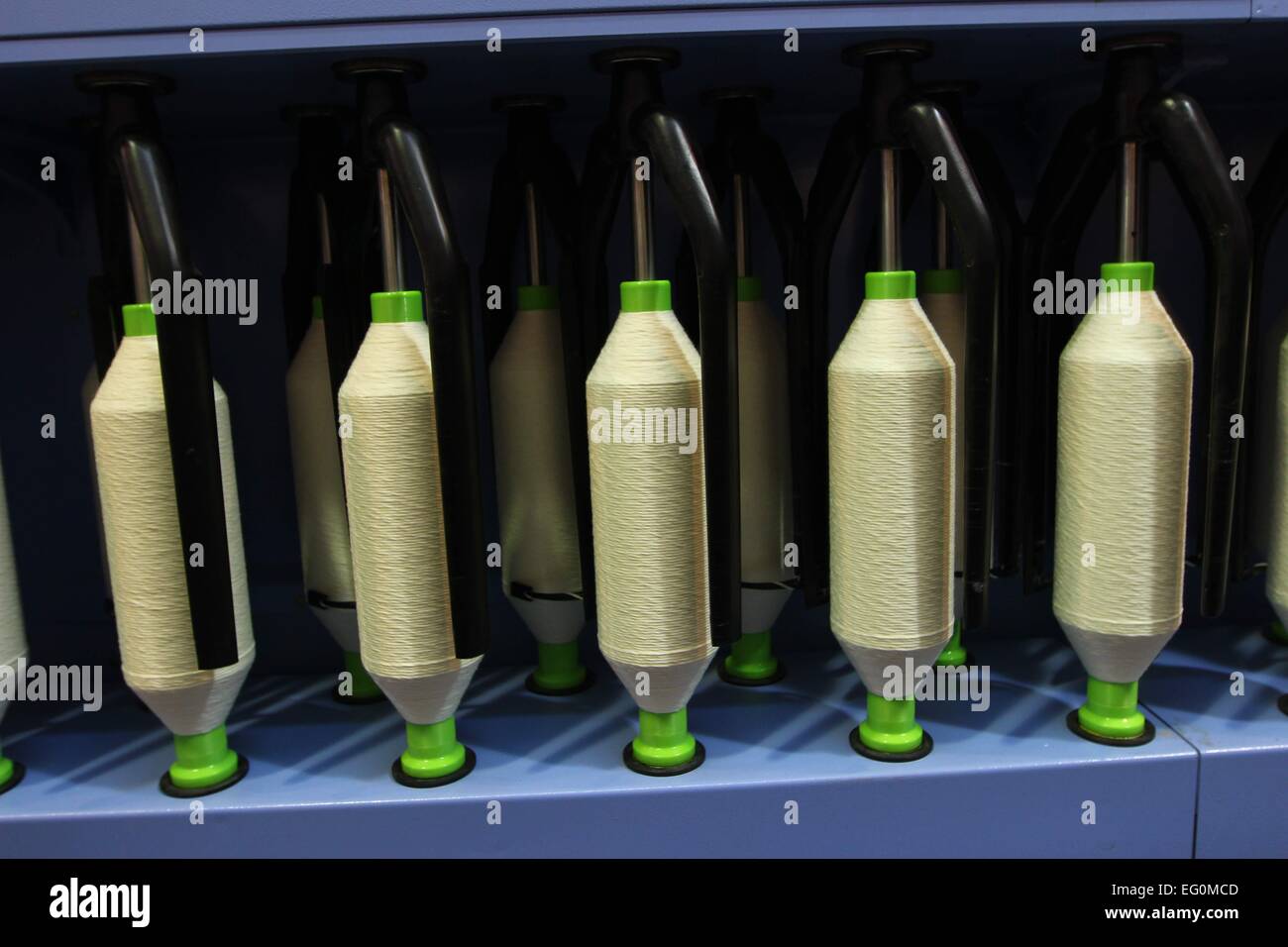 Dhaka 09 February 2015. Group of bobbin thread cones on a warping ...