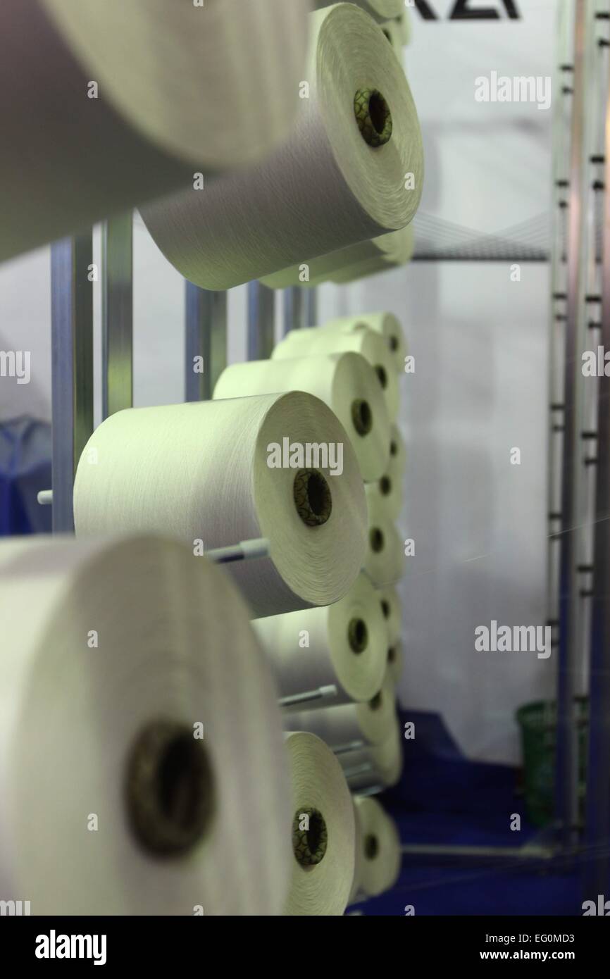 Dhaka 09 February 2015. Group of bobbin thread cones on a warping ...