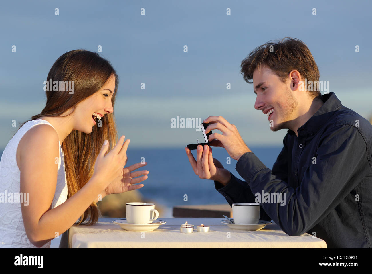 Boyfriend requesting hand of his girlfriend with a engagement ring in a