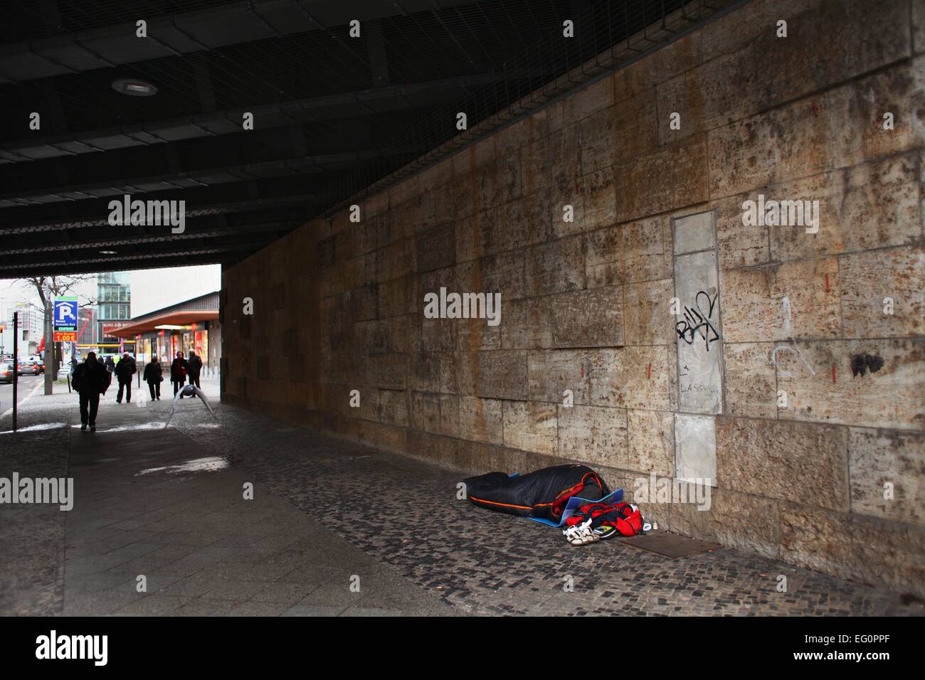 A homeless man lying in a sleeping bag under a bridge in Berlin, January 29, 2015. Photo: Wolfram Steinberg/dpa Stock Photo
