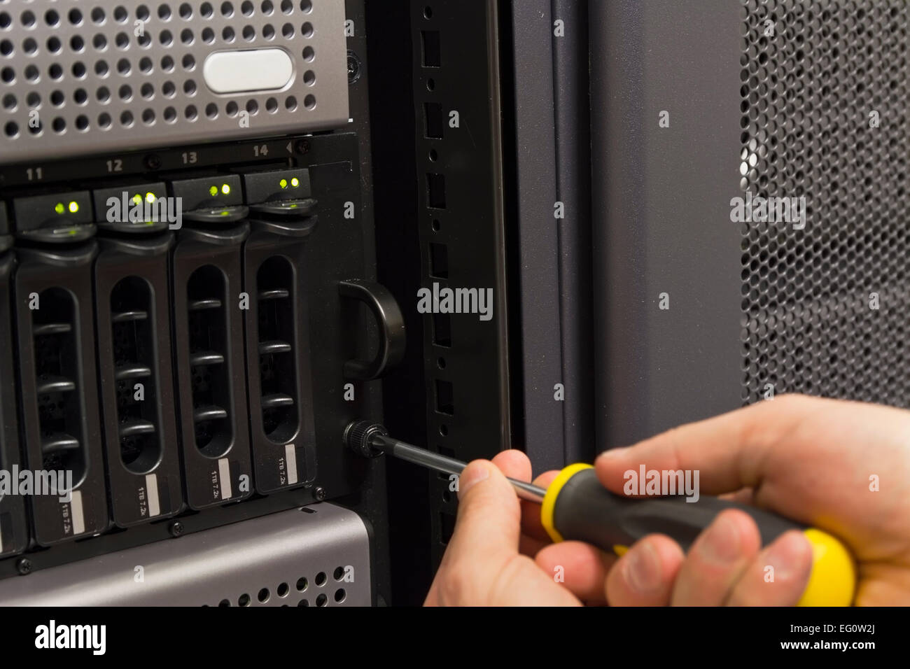 Installing server and disk cabinet / SAN in rack at a data center Stock ...