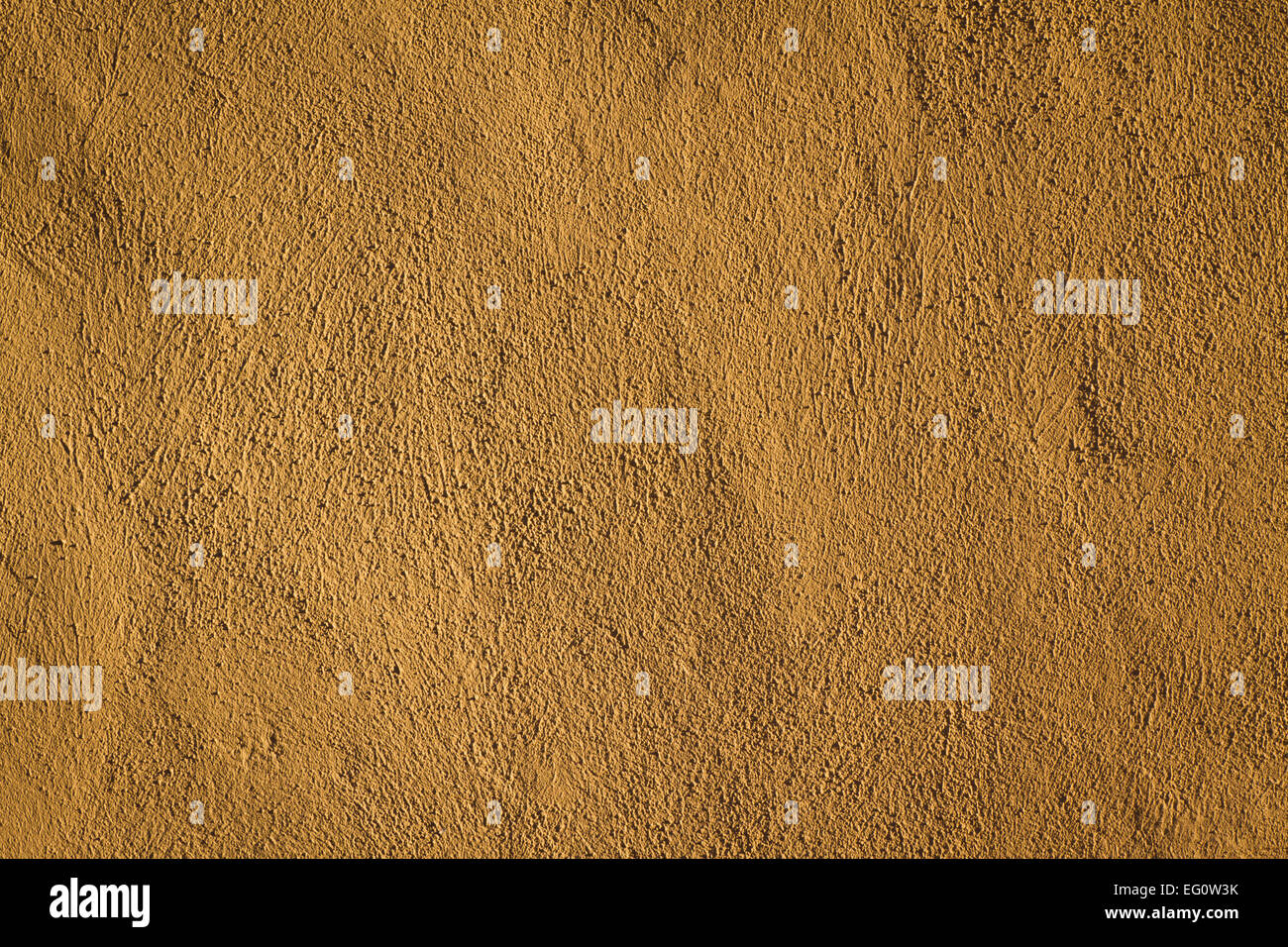 Wall image of a textured concrete wall. It's a brown / orange colored background. Stock Photo