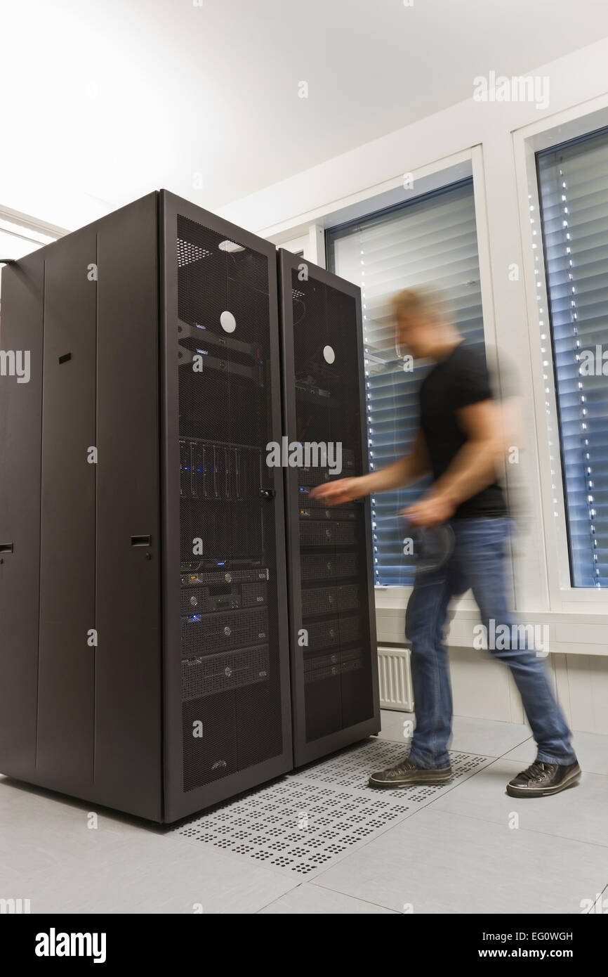 It engineer / consultant working in a data center. Holding a ethernet (Cat 5 / 6) cable. Stock Photo