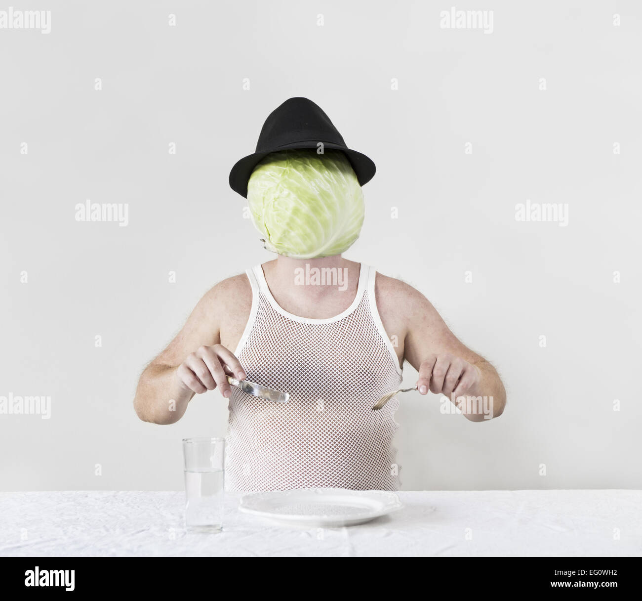 Wierd cabbage man with hat and nothing on the plate. Stock Photo