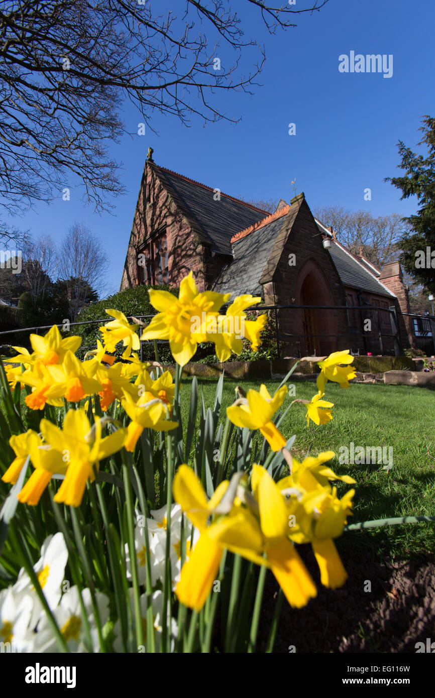 Village of Caldy, Cheshire. Picturesque spring view of the Church of the Resurrection and All Saints at Caldy. Stock Photo