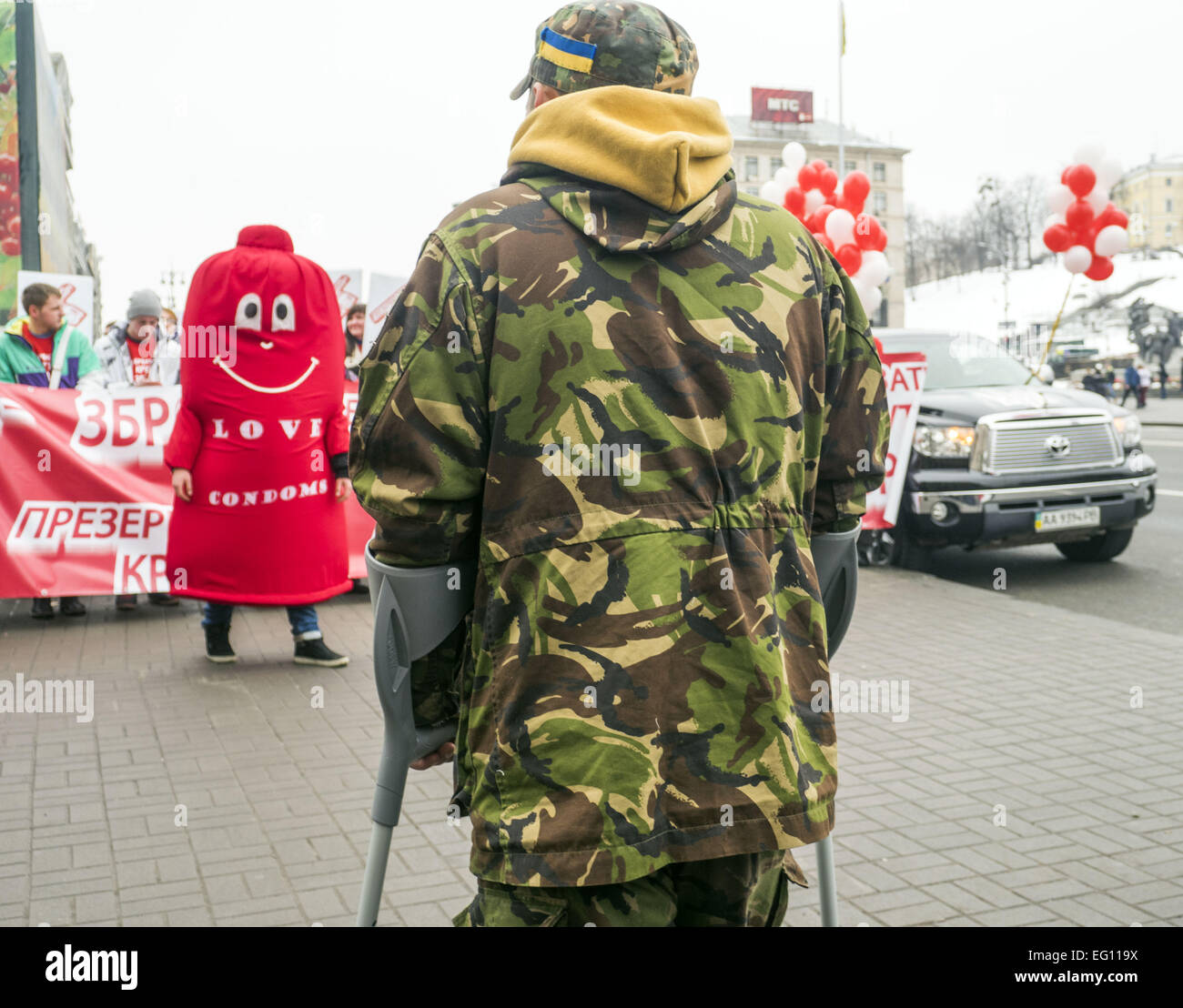 Feb. 13, 2015 - Wounded soldier watches the action in honor of the Condom  Day -- February 13, 2015 in Kiev, Ukraine, celebrated the Day of the condom.  By the symbolic action