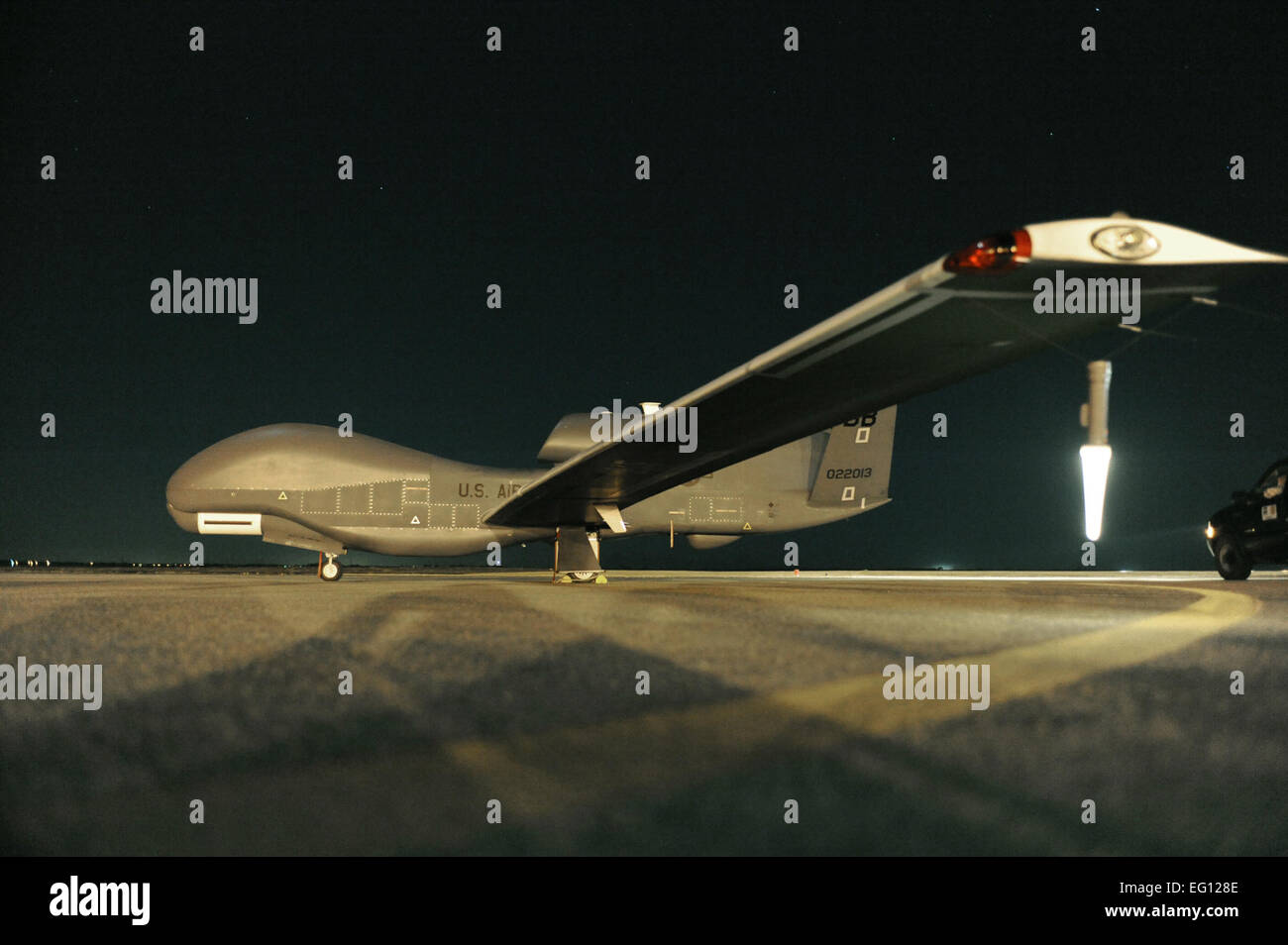 An RQ-4 Global Hawk sits on the runway before beginning a nighttime ...