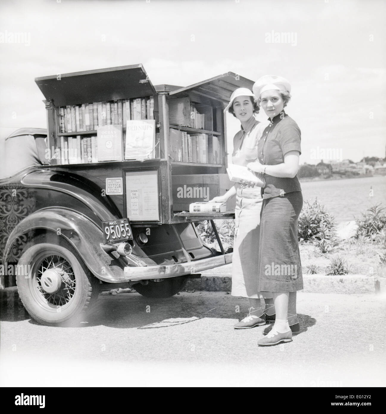 Antique 1936 photograph, traveling Plymouth bookmobile car in Cape Cod, Massachusetts, USA. Stock Photo