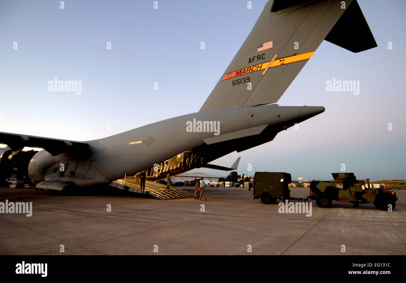 A C-17A Globemaster crew from the 729th Airlift Squadron, out of March, Air Reserve Base., unload supplies and equipment Friday, January 15th, 2010, at the Port -au-Prince International Airport, Haiti.  The C-17 and crew, both out of the 452nd Air Mobility Wing at March Air Reserve Base, are taking part in the massive international effort to assist in rescue, recover and humanitarian efforts following a 7.0 earthquake. President Barack Obama ordered a swift and aggressive rescue effort.  The January 12, 2010 quake, centered near the island nation's capital of Port-au-Prince, has left untold nu Stock Photo