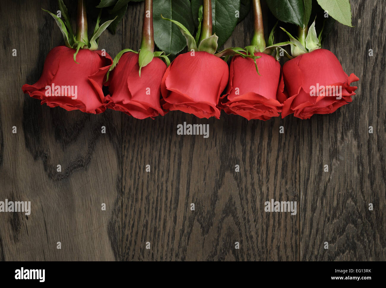 Romantic background with red roses on wood table Stock Photo - Alamy