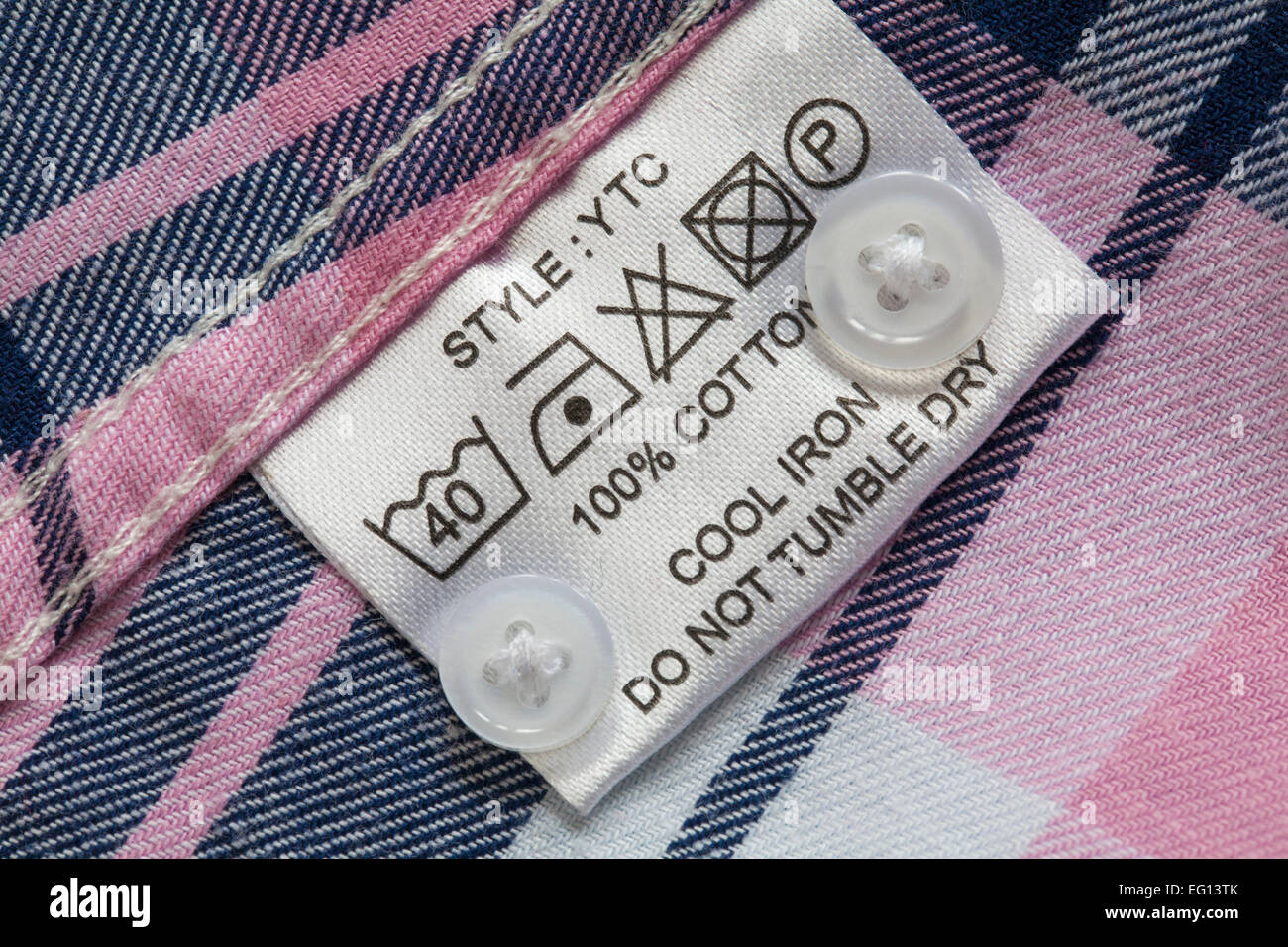 label showing washing instructions in 100% cotton check shirt with ...