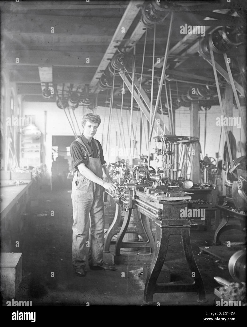 Antique c1910 photograph, boy machinist at machine shop, probably Massachusetts, USA. Stock Photo