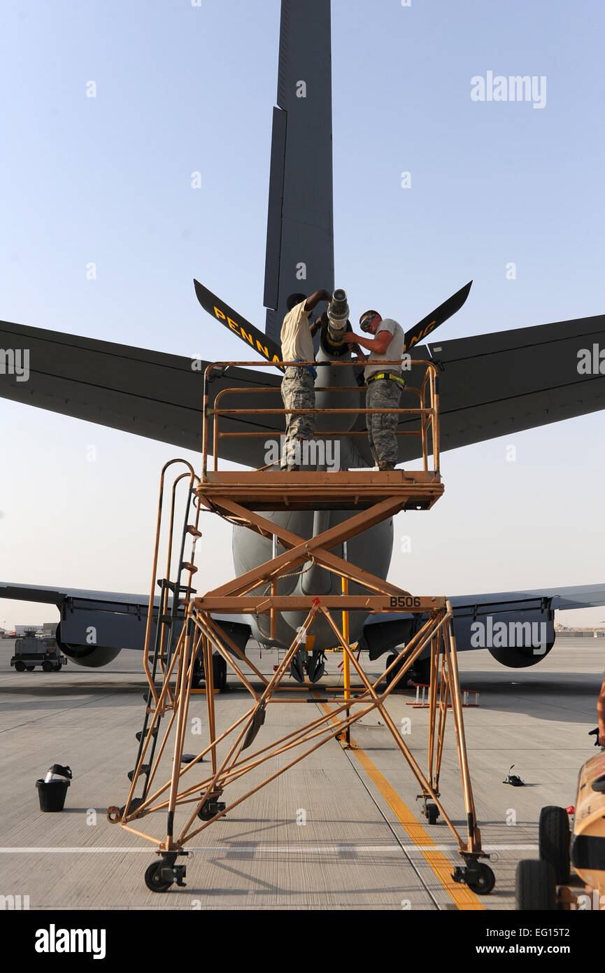Tech. Sgt. Fredick Mabry left and Airman 1st Class Daniel Winders right, 379th Expeditionary Aircraft Maintenance Squadron crew chiefs, re-install a KC-135 boom nozzle at a non-disclosed Southwest Asia location May 10, 2010.  Senior Airman Kasey Zickmund Stock Photo