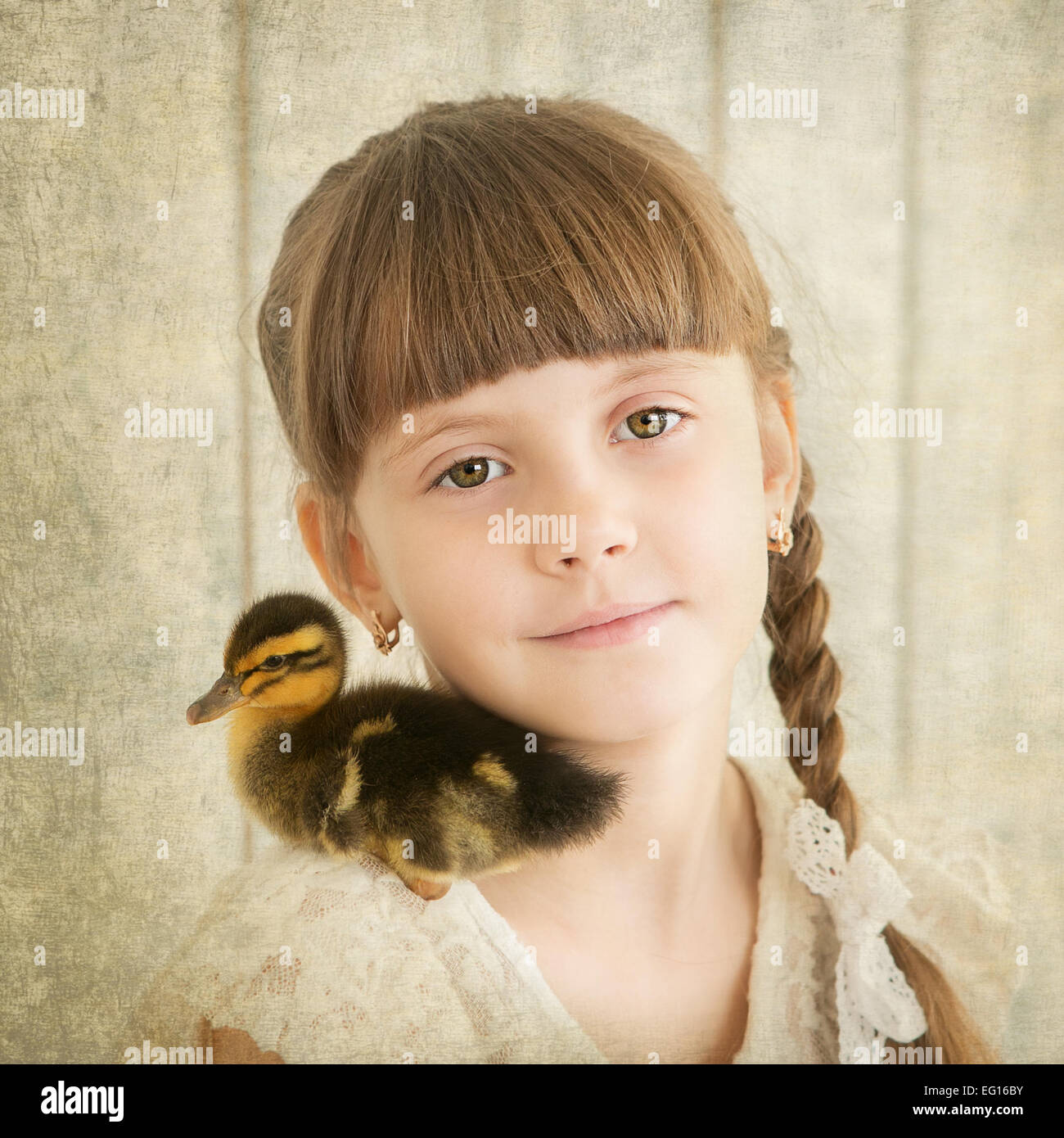 portrait of girl with duckling on shoulder Stock Photo