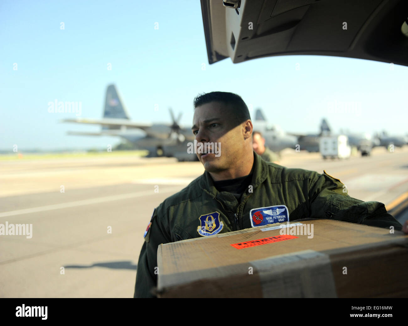 Tech. Sgt. Gabe Peterson, a WC-130J Hercules weather reconnaissance loadmaster, assigned to the 53rd Reconnaissance Squadron ''Hurricane Hunters,'' loads a vehicle with the aircrew's equipment and luggage for a deployment on Sept. 15, 2010, at Keesler AFB. Staff Sgt. Manuel J. Martinez Stock Photo