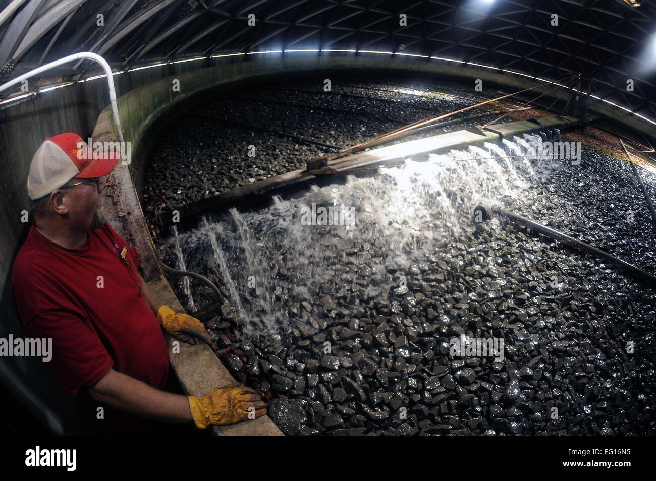 Carl Johnson, plant operator, observes the trickling filter at the