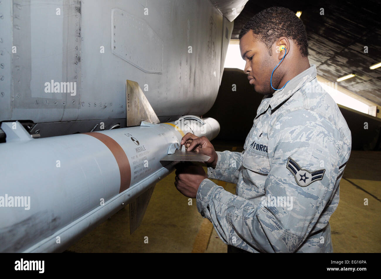 Airman 1st Class Billy Reams gives the final touches to the munitions load by securing the last fins on an AIM-120 Advanced Medium-Range Air-to-Air Missile Sept. 23, 2010, at Keflavik, Iceland.  Airman Reams is a team member of the 493rd Expeditionary Fighter Squadron Weapons Load Crew.  Senior Airman Stephen Linch Stock Photo