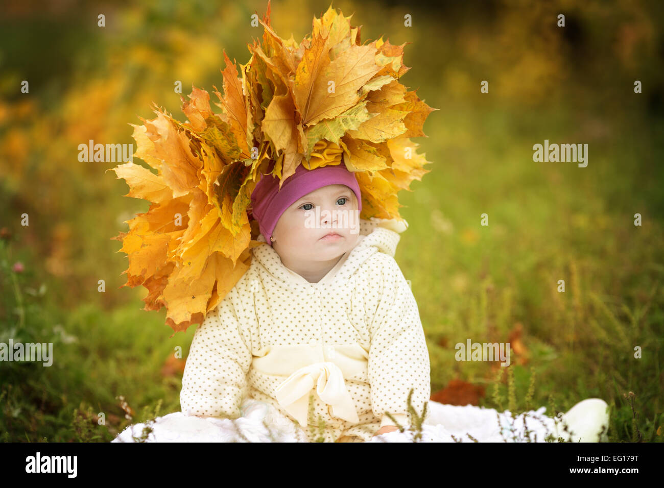 Girl with Down syndrome wore a wreath of spring leaves Stock Photo