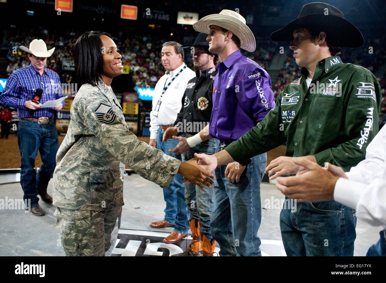 U.S. Air Force Master Sgt. Kisha Washington 99th Logistics Readiness Squadron shakes hands with professional bull riders at the Professional Bull Riding Finals at the Thomas and Mack Center Oct. 22, 2010. Nellis Air Force Base Airmen were honored for their service to the country during Air Force night at the PBR Finals .  U.S. Air Force photo / Tech. Sgt. Michael R. Holzworth Stock Photo