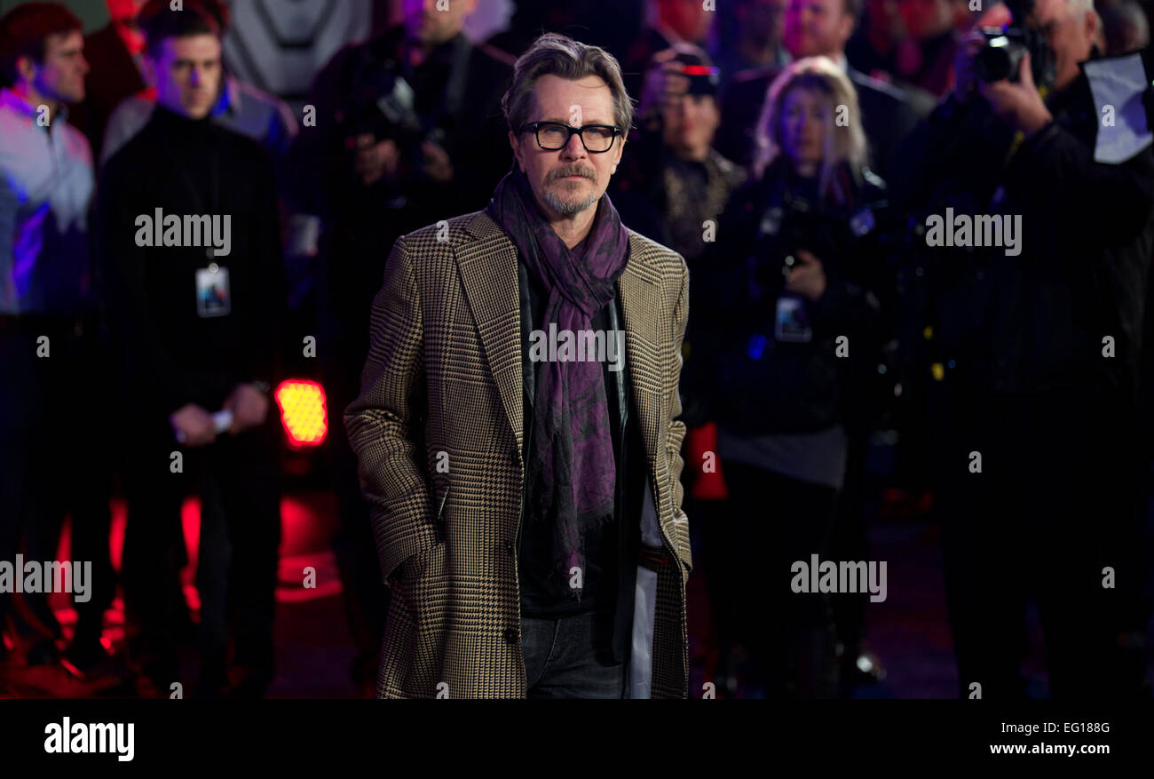 UNITED KINGDOM: British actor Gary Oldman poses for pictures on the red carpet as he arrives for the world premier of 'Robocop' in central London on February 5, 2014. Stock Photo