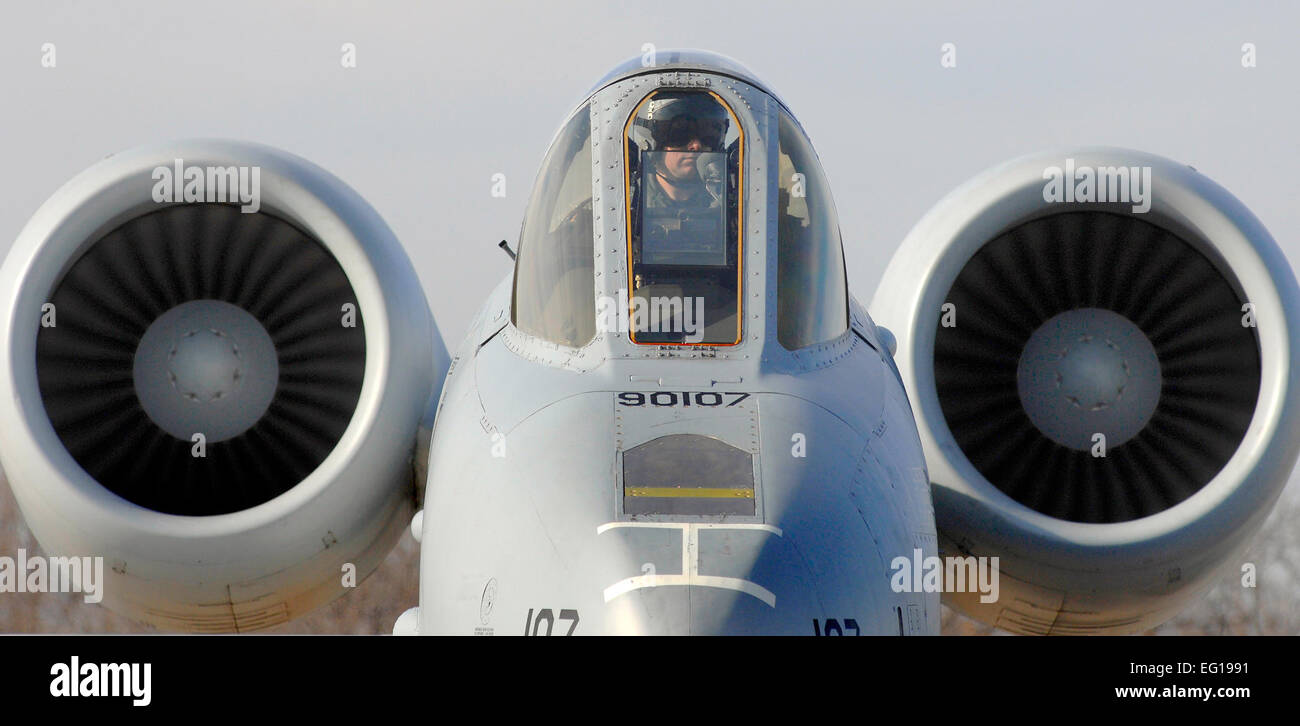 A pilot with the 442nd Fighter Wing sits on the ramp in his A-10 Thunderbolt II while crew chiefs perform a hot pit refuel for his aircraft at Whiteman Air Force Base, Mo., on Dec. 8, 2010.  Hot pit refueling is a procedure usually performed in a combat situation to rapidly refuel aircraft while engines are running to thrust pilots back into the fight.  The technicians with the 442nd Fighter Wing are practicing this procedure to keep their skills sharp.  DoD photo by Senior Airman Kenny Holston, U.S. Air Force.  Released Stock Photo