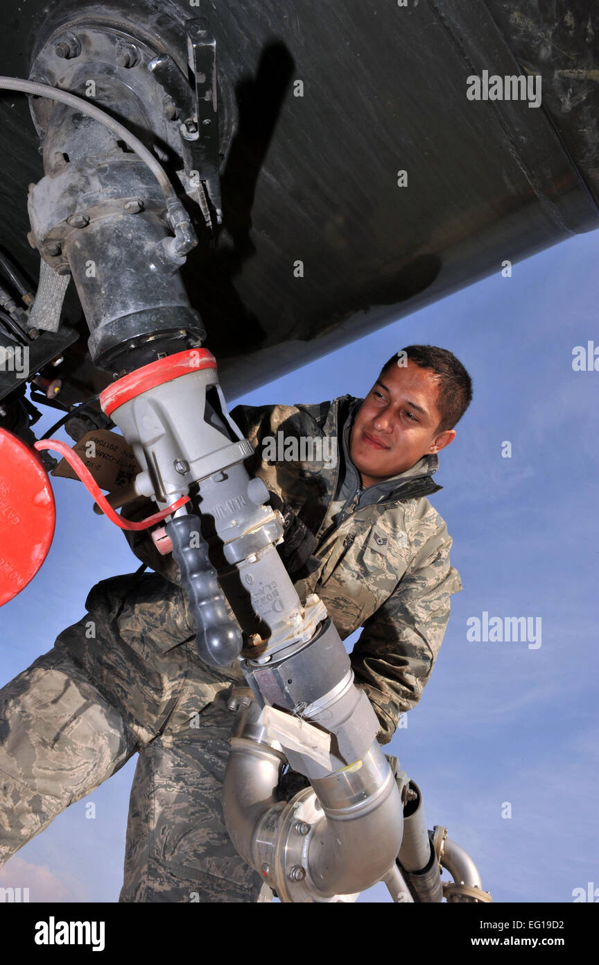 U.S. Air Force Staff Sgt. Keoni Brede, a 455th Expeditionary Logistics Readiness Squadron ELRS distribution operator, hooks a panagraph arm from the fuelstand operation to the R-11 refueling vehicle at Bagram Airfield, Afghanistan, Jan. 21, 2011. The 455 ELRS R-11 refuels an average of 30 times a day. Sergeant Brede is a native of Ewa Beach, Hawaii, and is deployed from Nellis Air Force Base, Nev.  Senior Airman Sheila Devera Stock Photo