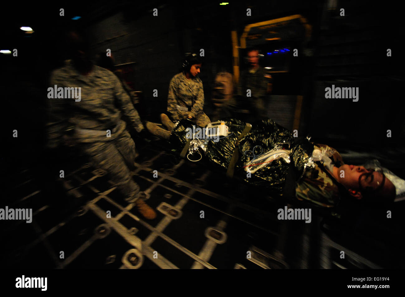 A U.S. Air Force Surgical Team assigned to the 1st Special Operations Support Squadron Hurlburt Field Fla., litter carries wounded patients off a MC-130H Combat Talon II onto medical trucks for transport to medical treatment centers during Emerald Warrior on March. 1, 2011. Emerald Warrior 2011 is a U.S. Special Operations Command-sponsored, multiservice exercise designed to leverage lessons learned from Operations Iraqi Freedom and Enduring Freedom to provide trained and ready forces to combatant commanders. USAF photo by SSgt Andy M. KinReleased Stock Photo