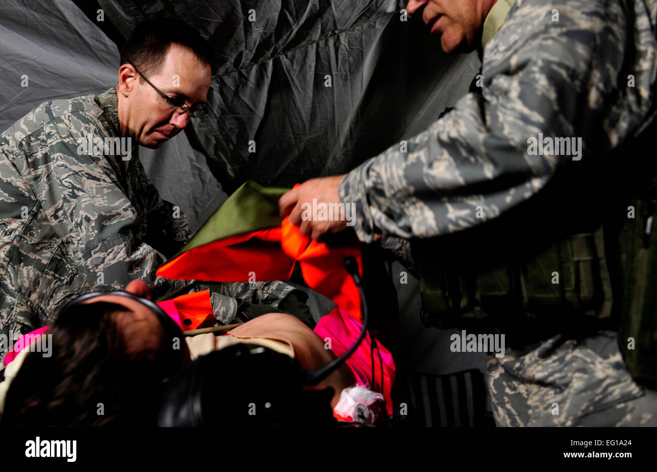 U.S. Air Force Maj. Dr. James Collins, an emergency room doctor assigned to the 1st Special Operations Support Squadron, Hurlburt Field, Fla., treats a critical patient in the surgical a tent during Emerald Warrior, March 3, 2011. Emerald Warrior is a U.S. Special Operations Command-sponsored, multiservice exercise designed to leverage lessons learned from Operations Iraqi Freedom and Enduring Freedom to provide trained and ready forces to combatant commanders. USAF photo by SSgt Andy M. KinReleased Stock Photo