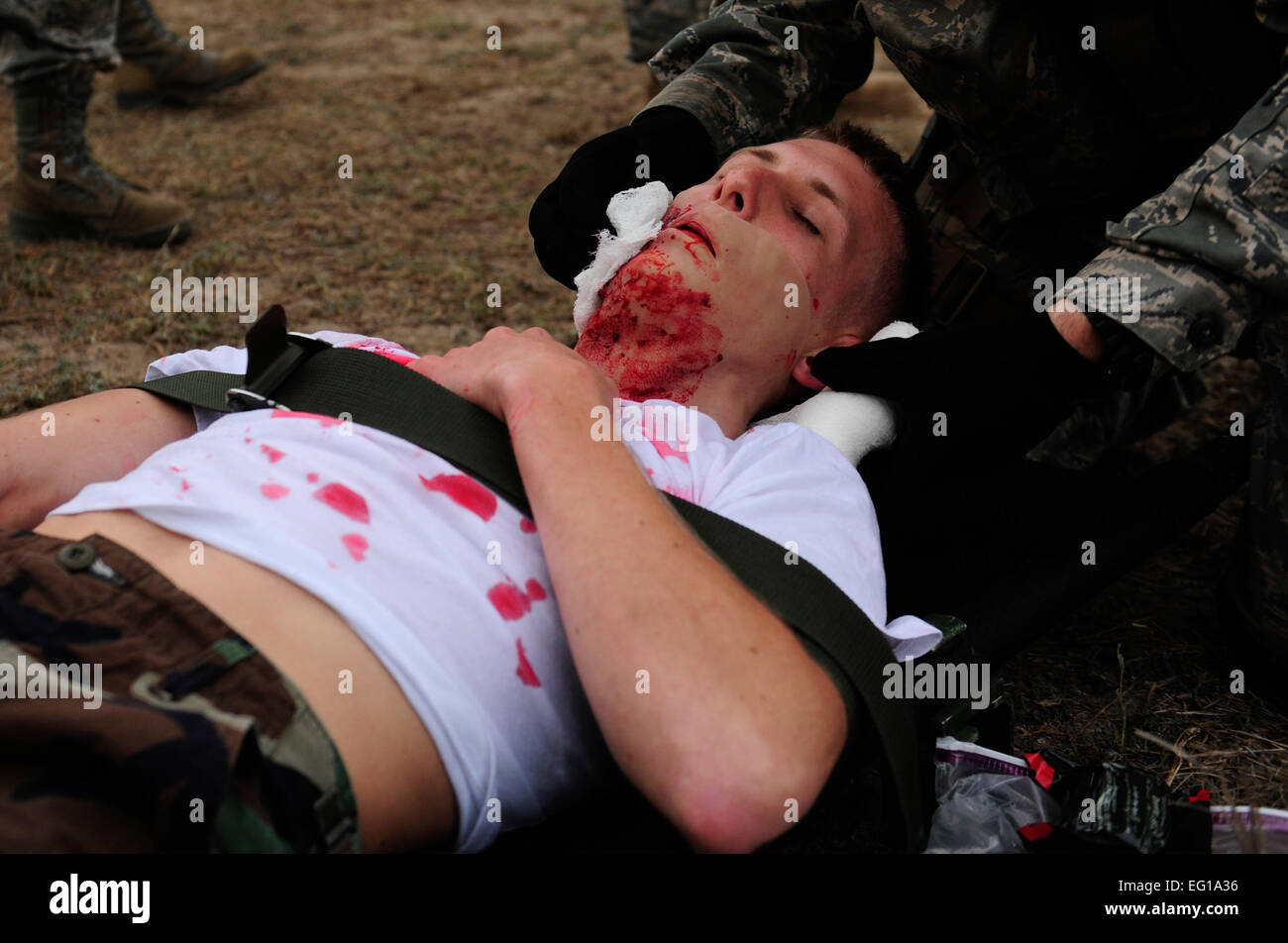 U.S. Air Force Maj. Dr. Jason Webb, a General Surgeon assigned to the 1st Special Operations Support Squadron, Hurlburt Field, Fla., secures a 'casualty's' neck and chin with a bandage during Emerald Warrior, March 4, 2011. Emerald Warrior is a U.S. Special Operations Command-sponsored, multiservice exercise designed to leverage lessons learned from Operations Iraqi Freedom and Enduring Freedom to provide trained and ready forces to combatant commanders. USAF photo by SSgt Andy M. KinReleased Stock Photo