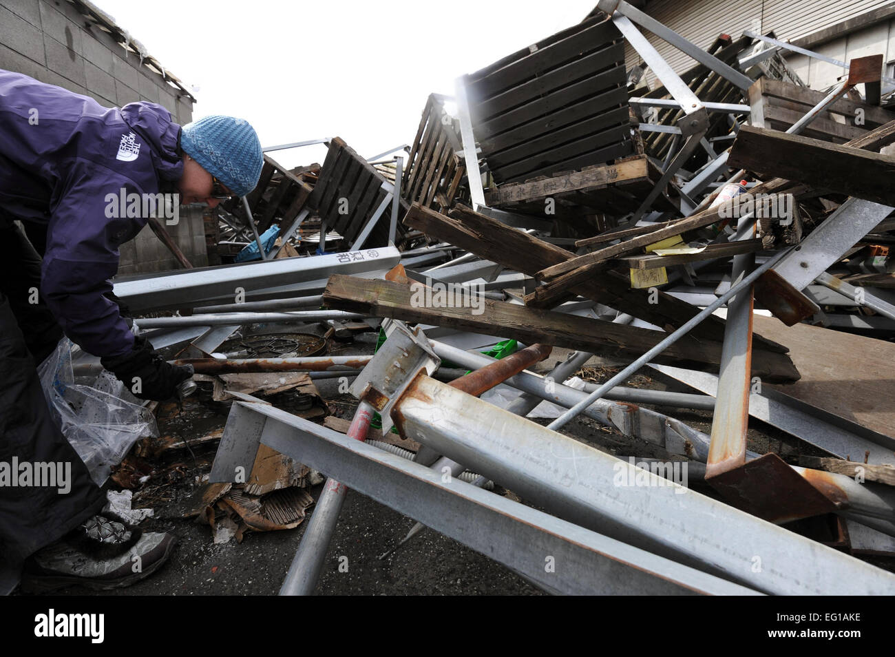 Kendall Nations, wife of Capt. Nations of the 14th Fighter Squadron, volunteers to help with the recovery efforts in the town of Hachinohe, Japan, March 17.  Hachinohe suffered massive damage due to the recent tsunami that came after the 9.1 earth quake on March 11.  Staff Sgt. April Quintanilla Stock Photo