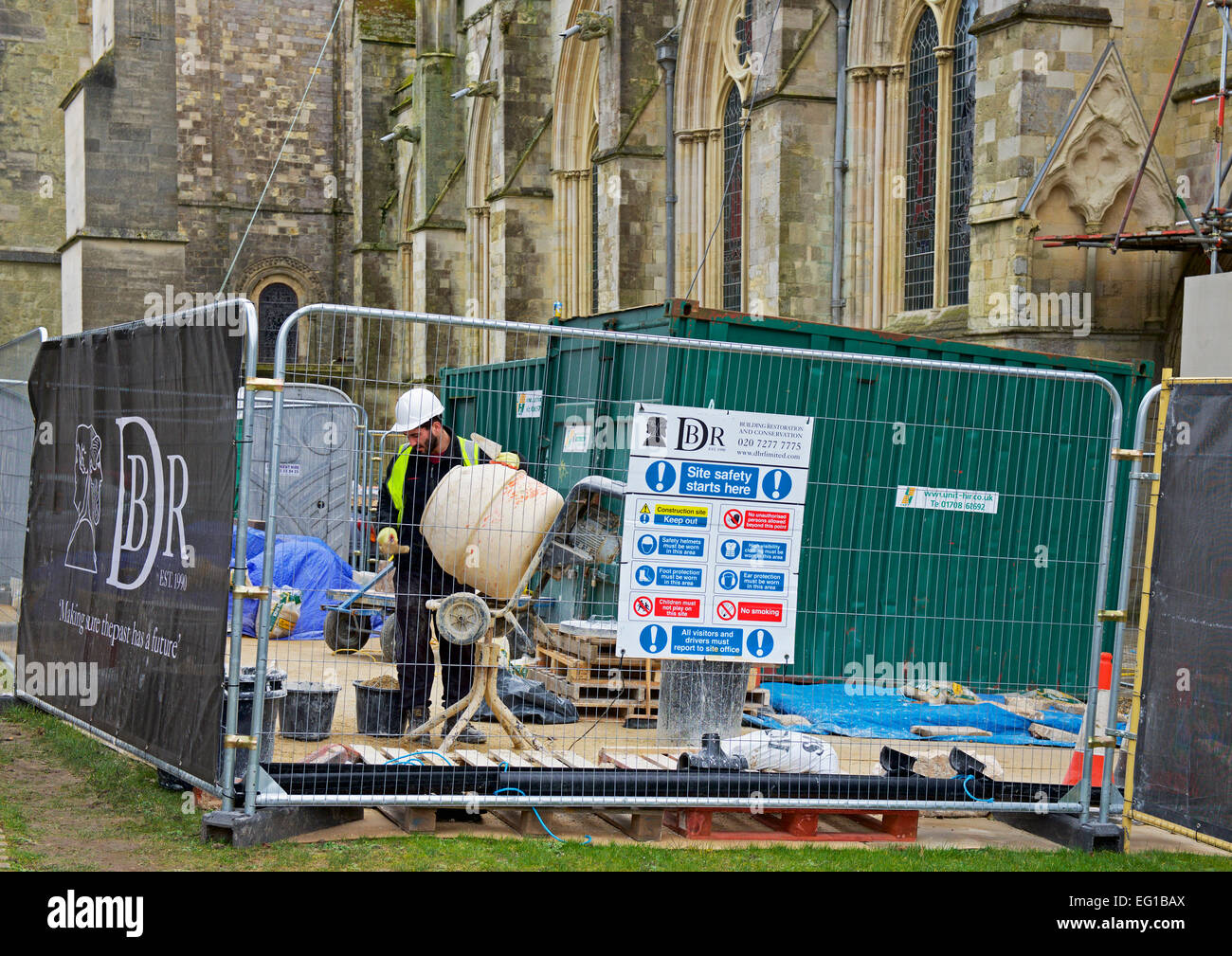 Man mixing cement during restoration work on Chichester Cathedral, Hampshire, England UK Stock Photo