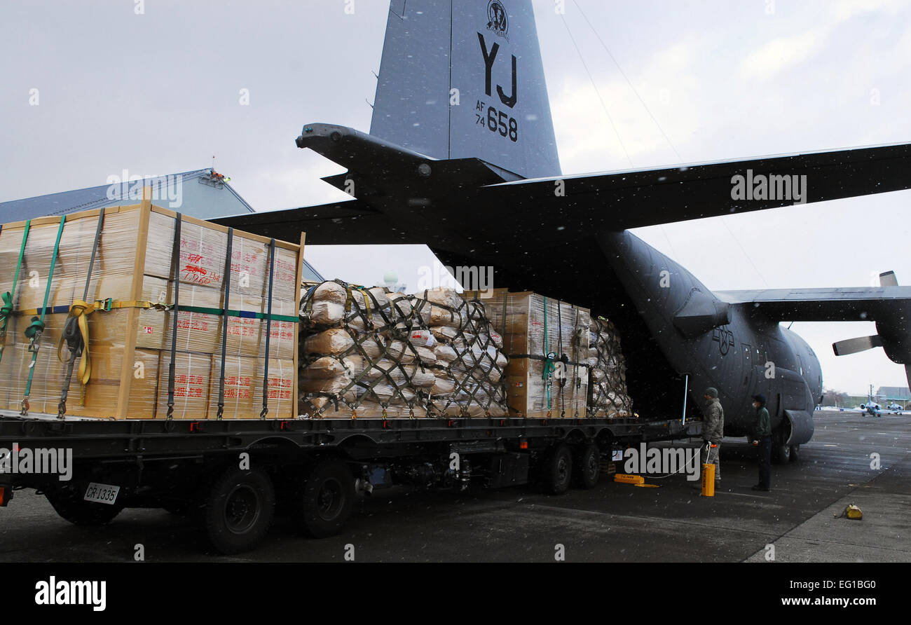 A U.S. Air Force C-130 Hercules cargo aircraft assigned to the 36th Airlift Squadron at Yokota Air Base, Japan, prepares to transport humanitarian relief supplies from Chitose Air Base, Japan, to Matsushima, Japan, March 23, 2011. The six pallets contain 15,000 pounds of water, rice and blankets.  Staff Sgt. Robin Stanchak Stock Photo