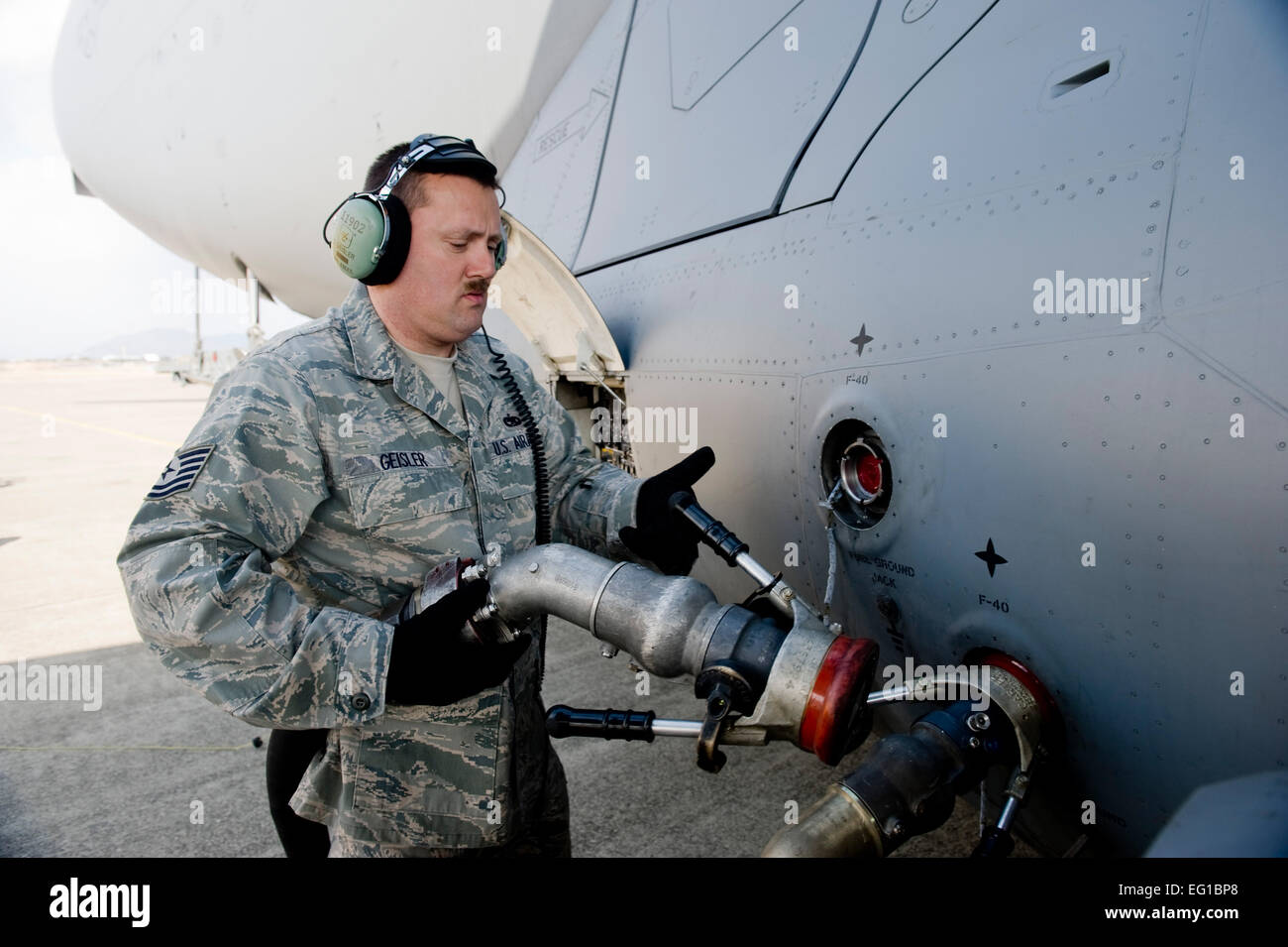 MARINES CORPS AIR STATION IWAKUNI, Japan – Tech Sgt. Chris Geisler, 176th Aircraft Maintenance Squadron, removes a fuel nozzle from C-17 Globemaster III here March 25. The C-17 flew from Yokota Air Base into Marines Corps Air Station Iwakuni to pick up marines from Marine Wing Support Squadron MWSS 171 to drop off them at Sendai Airport. MWSS-171 where heading to Sendai Airport to setup portable showers to bring humanitarian assistance to Japan in part of Operation Tomodachi. Staff Sgt. Jonathan Steffen Stock Photo