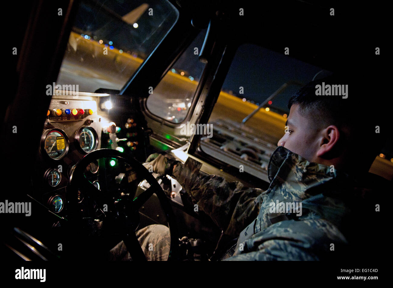 YOKOTA AIR BASE, Japan -- An Airman from the 730th Air Mobility Squadron operates a K-loader while unloading a C-17 Globemaster III here March 29. The C-17 carried water pumps and hoses to help stabilize the nuclear power plant in Japan in support of Operation Tomodachi. Staff Sgt. Chad C. Strohmeyer Stock Photo