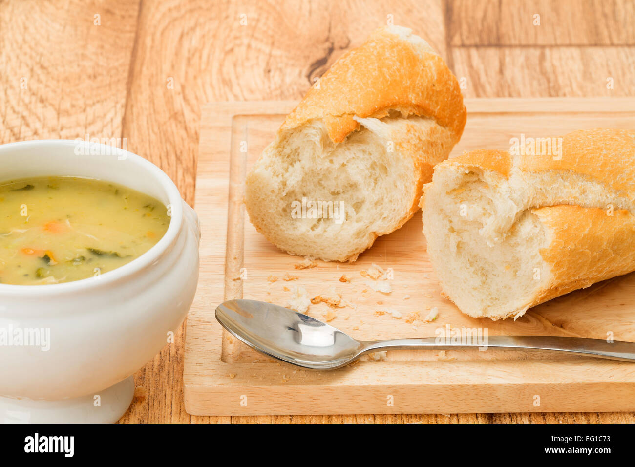 A bowl of vegetable soup with fresh crusty bread - studio shot Stock Photo