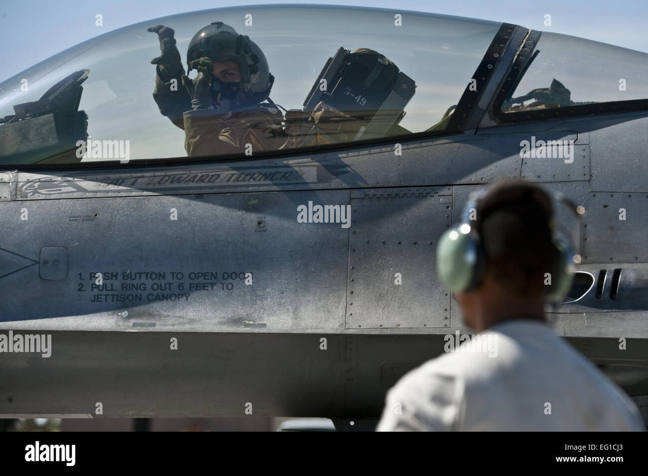 U.S. Air Force Capt. Jeremy Nolting, a pilot from the 79th Fighter Squadron, Shaw Air Force Base, S.C., shows the 79th FS "tiger claw" sign from the cockpit of a F-16 Fighting Falcon before departing on a training mission at Nellis Air Force Base, Nev., during exercise Green Flag West 11-6, April 20, 2011. Green Flag West replicates irregular warfare conditions currently found in Southwest Asia. Aircrews, work closely with Air Force joint terminal attack controllers. Pilots train for a missions such as close air support, and aerial reconnaissance. Stock Photo