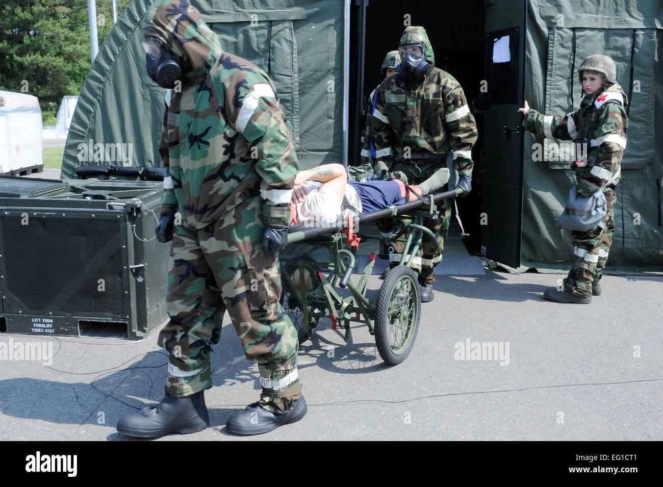 Decontamination team members transport a litter patient to the medical