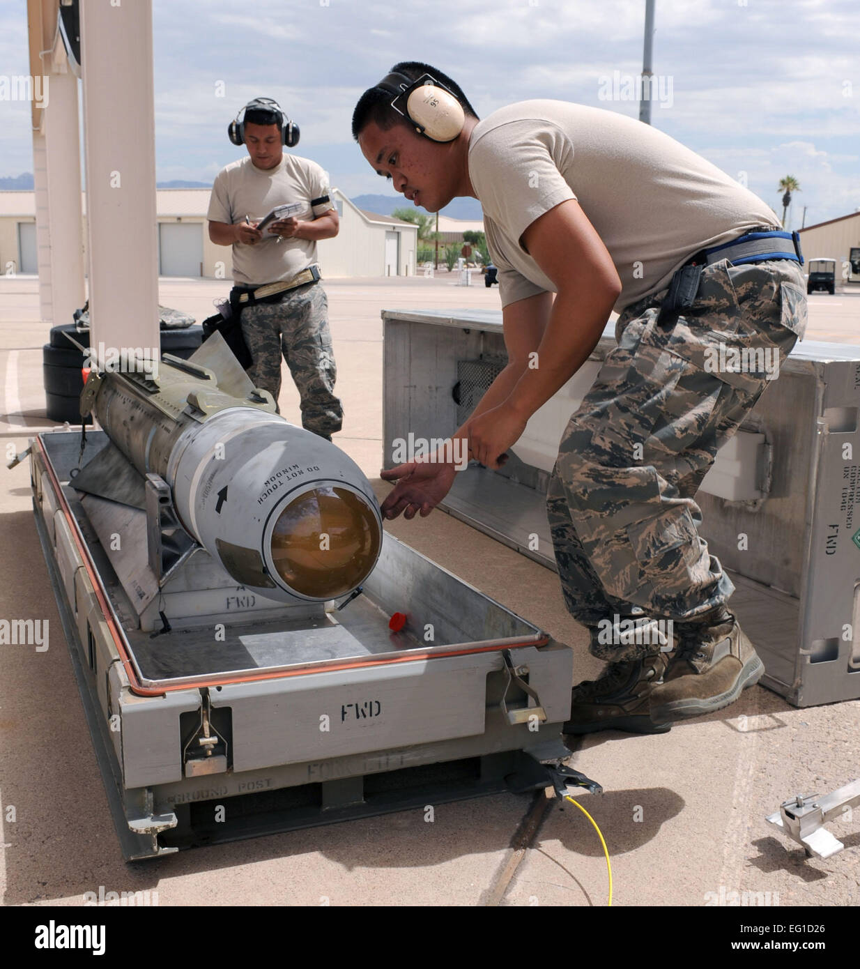Air Force Staff Sgt. Alston Biacan performs missile preparation on an AGM-65 during a load crew competition on the Davis Monthan Air Force Base, Ariz., flight line July 11, 2011.The competition is held quarterly and consists of a uniform inspection, written tests and performance tests.  Airman 1st Class Christine Halan Stock Photo