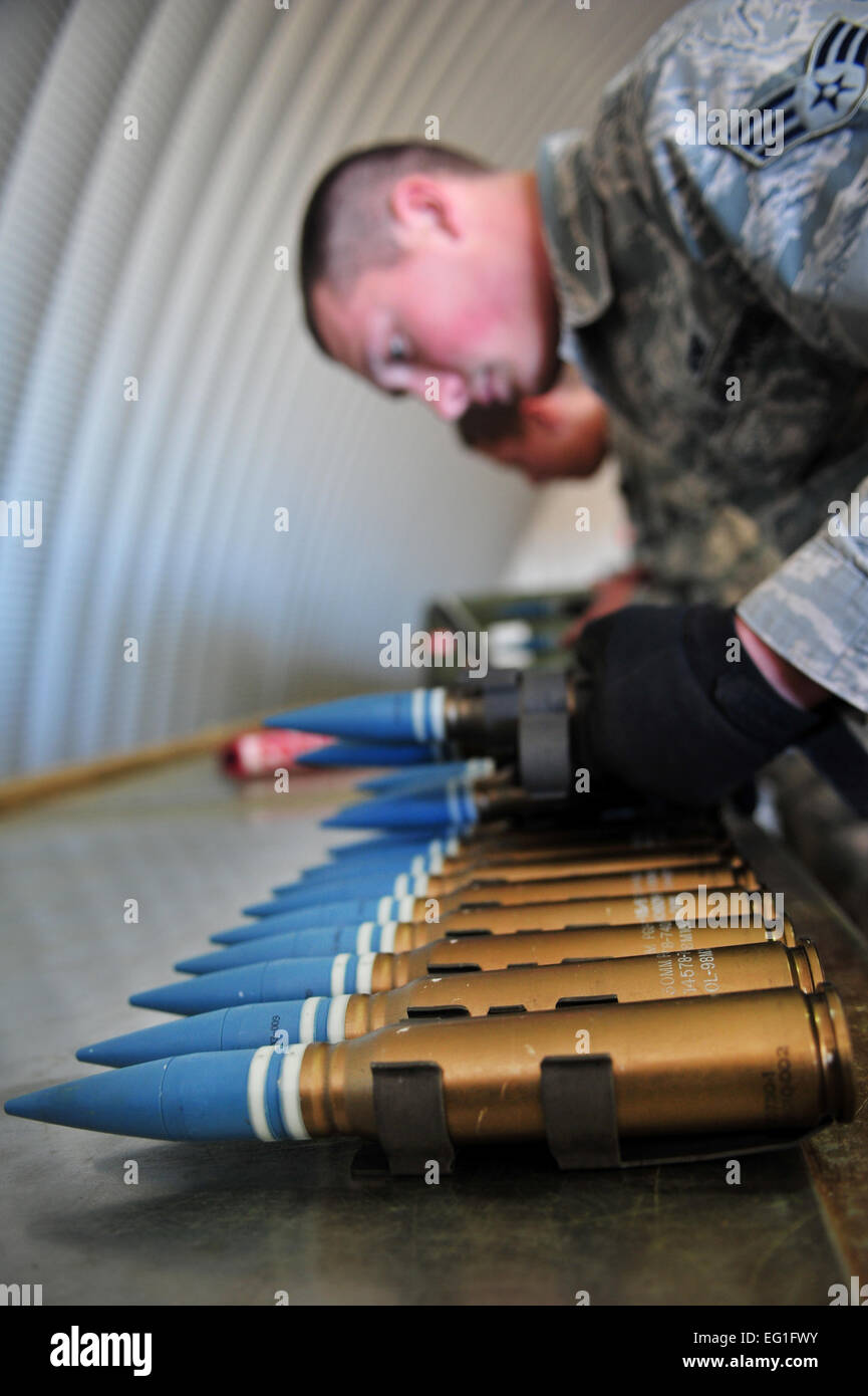 A maintainer with the 27th Special Operations Maintenance Squadron inspects 30 millimeter ammo rounds Dec. 18, 2014 at Cannon Air Force Base, N.M. Munition systems specialists receive, identify, inspect and store guided and unguided nonnuclear munitions.  Senior Airman Eboni Reece  For more great Air Force photos, visit our Facebook page: www.facebook.com/usairforce  https://www.facebook.com/USairforce  . Stock Photo