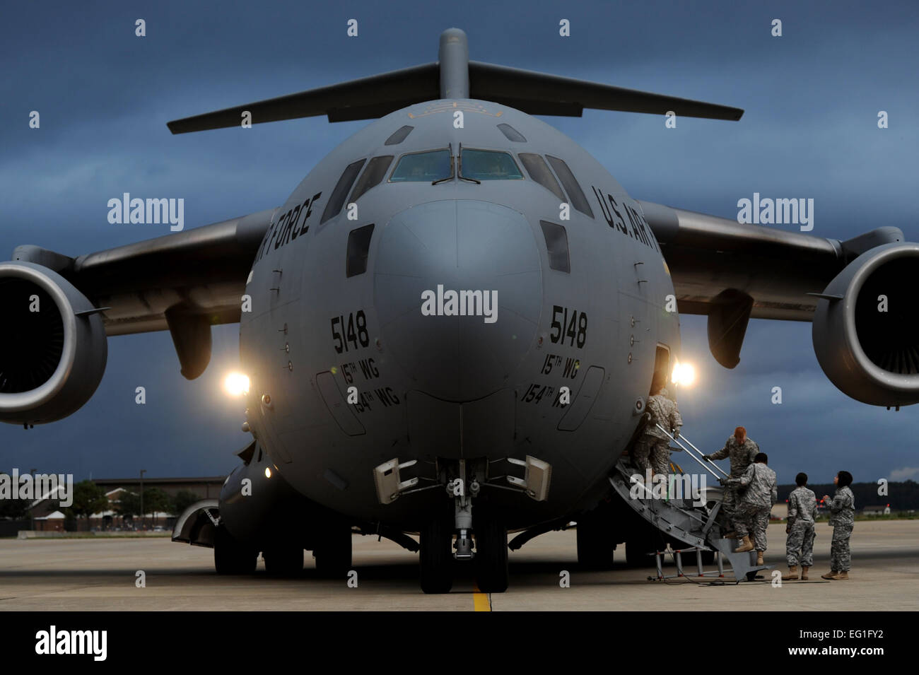 Army Soldiers board a C-17 Globemaster III during an unloading mission Oct. 23, 2013, at Langley Air Force Base, Va. The Soldiers partnered with Airmen from the 633rd Logistics Readiness Squadron to learn how to properly unload large airframes. The Soldiers are assigned to the 622nd Movement Control Detachment from Fort Eustis, Va. Staff Sgt. Jarad A. Denton Stock Photo