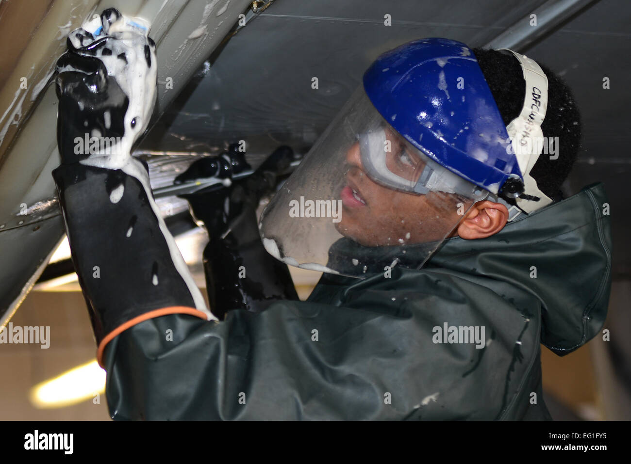 A maintainer from the 27th Special Operations Aircraft Maintenance Squadron scrubs beneath the wing of an MC-130J Commando II Dec. 18, 2014, at Cannon Air Force Base, N.M. Maintainers can spend hours washing an aircraft to ensure it is free of debris and safe from deterioration.  Airman 1st Class Shelby Kay-Fantozzi  For more great Air Force photos, visit our Facebook page: www.facebook.com/usairforce  https://www.facebook.com/USairforce  . Stock Photo