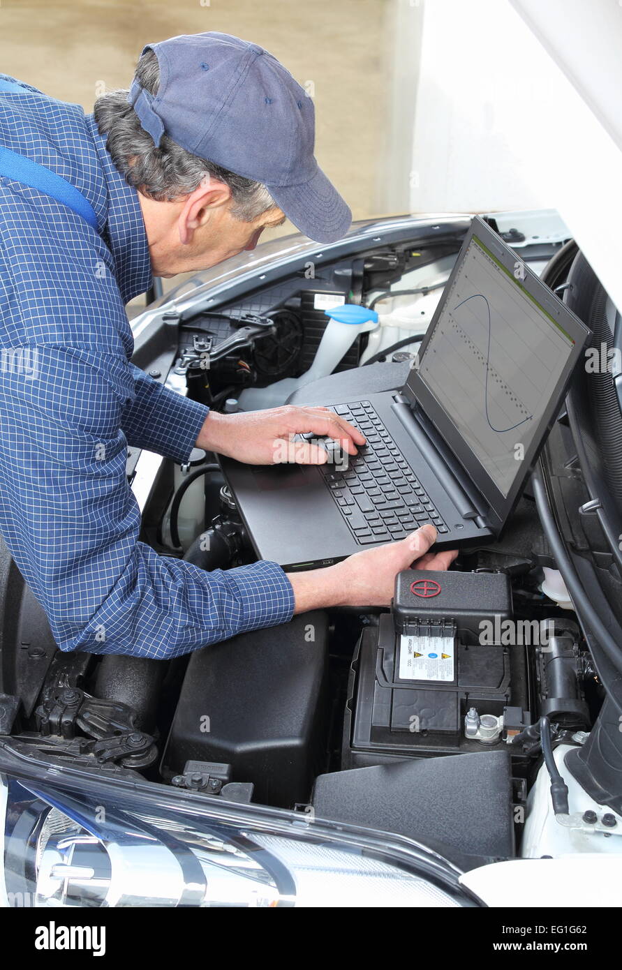 A Car Mechanics with diagnostic notebook on car Stock Photo