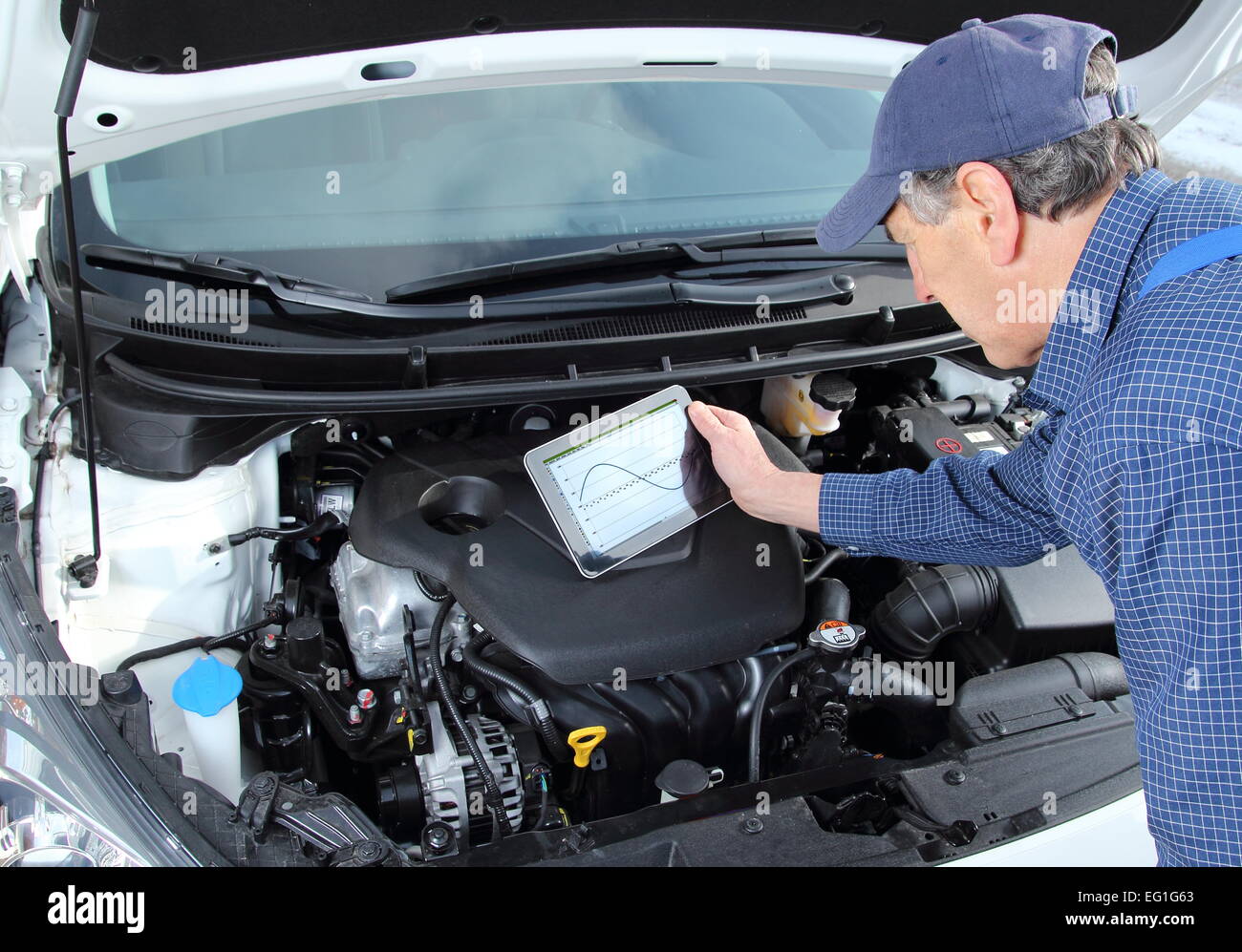 A car Mechanic with diagnostic equipment tablet Stock Photo
